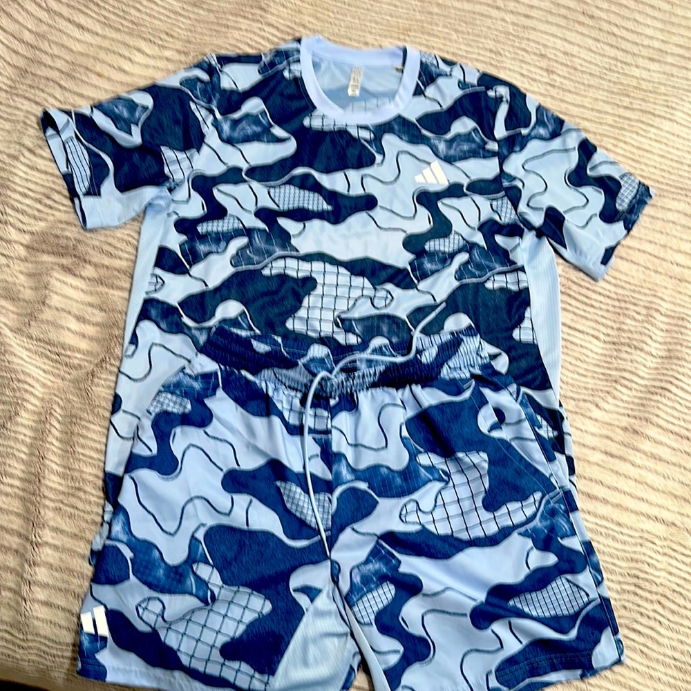 tennis set Adidas the shirt is a size large the shorts are a size medium.